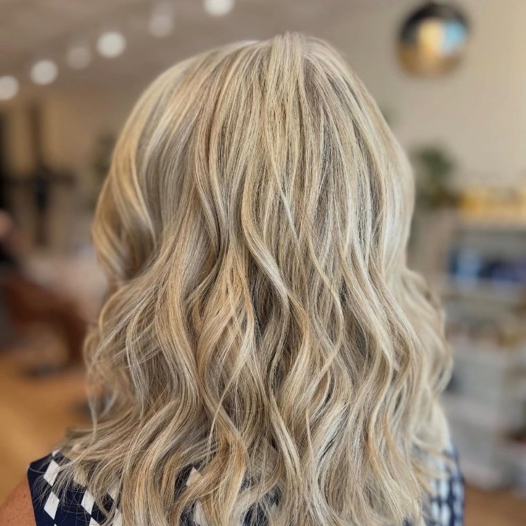 Cool beige-blonde hair in soft textured waves, seen from behind