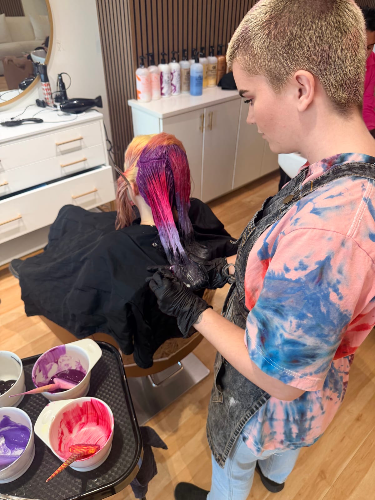 Overhead view of colour being applied at Canterbury & Co., mixing bowls and brushes on the trolley.